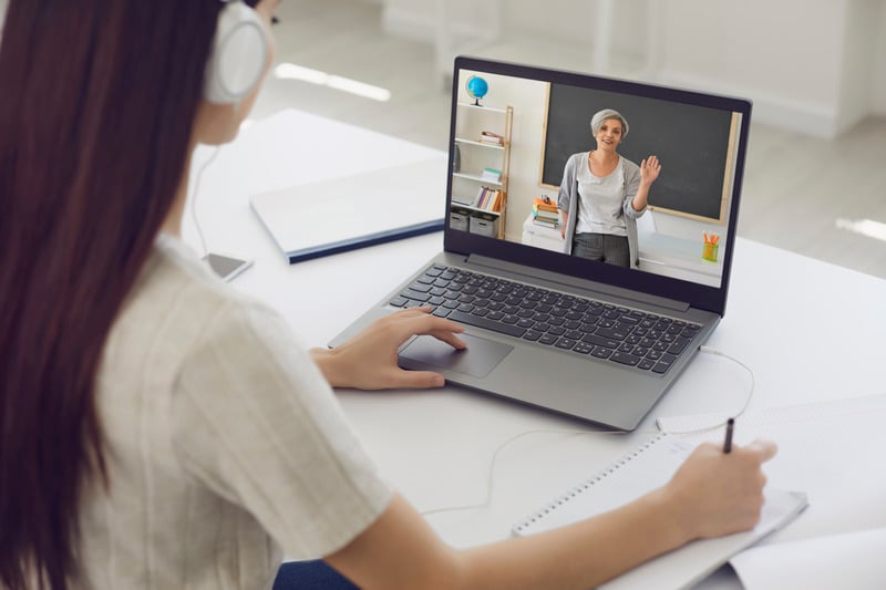 Woman attending online class on laptop